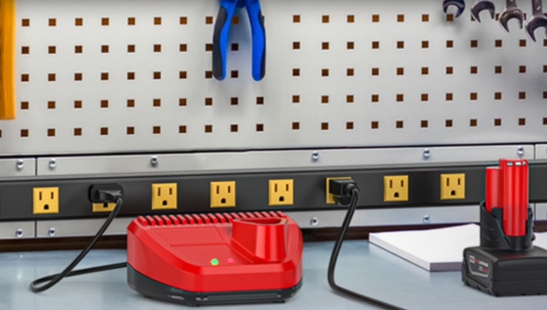 Wall-mounted CRST outlet rail with widely-spaced outlets on a workbench